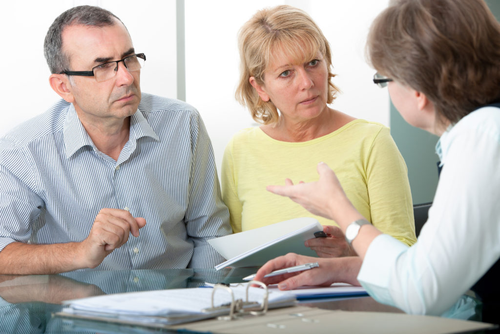 Couple getting financial advice from consultant at home